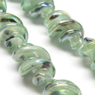 Lampwork stiklas susuktas švelniai žalsvas perlamutrinis 25x15 mm