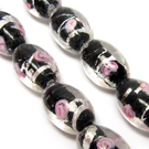 Lampwork karoliukas su sidabro folija ir gėlyte juodos spalvos 16x10 mm