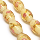 Lampwork karoliukas su sidabro folija ir gėlyte medaus spalvos 16x10 mm