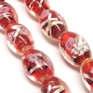 Lampwork karoliukas su sidabro folija ir gėlyte raudonos spalvos 16x10 mm