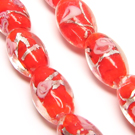 Lampwork karoliukas su sidabro folija ir gėlyte skaisčiai raudonos spalvos 16x10 mm